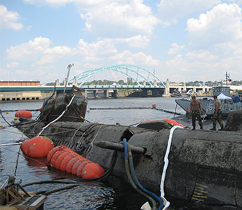 Salvage pontoons in use to resurrect a damaged submarine