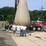 People standing in front of a full water load testing bag